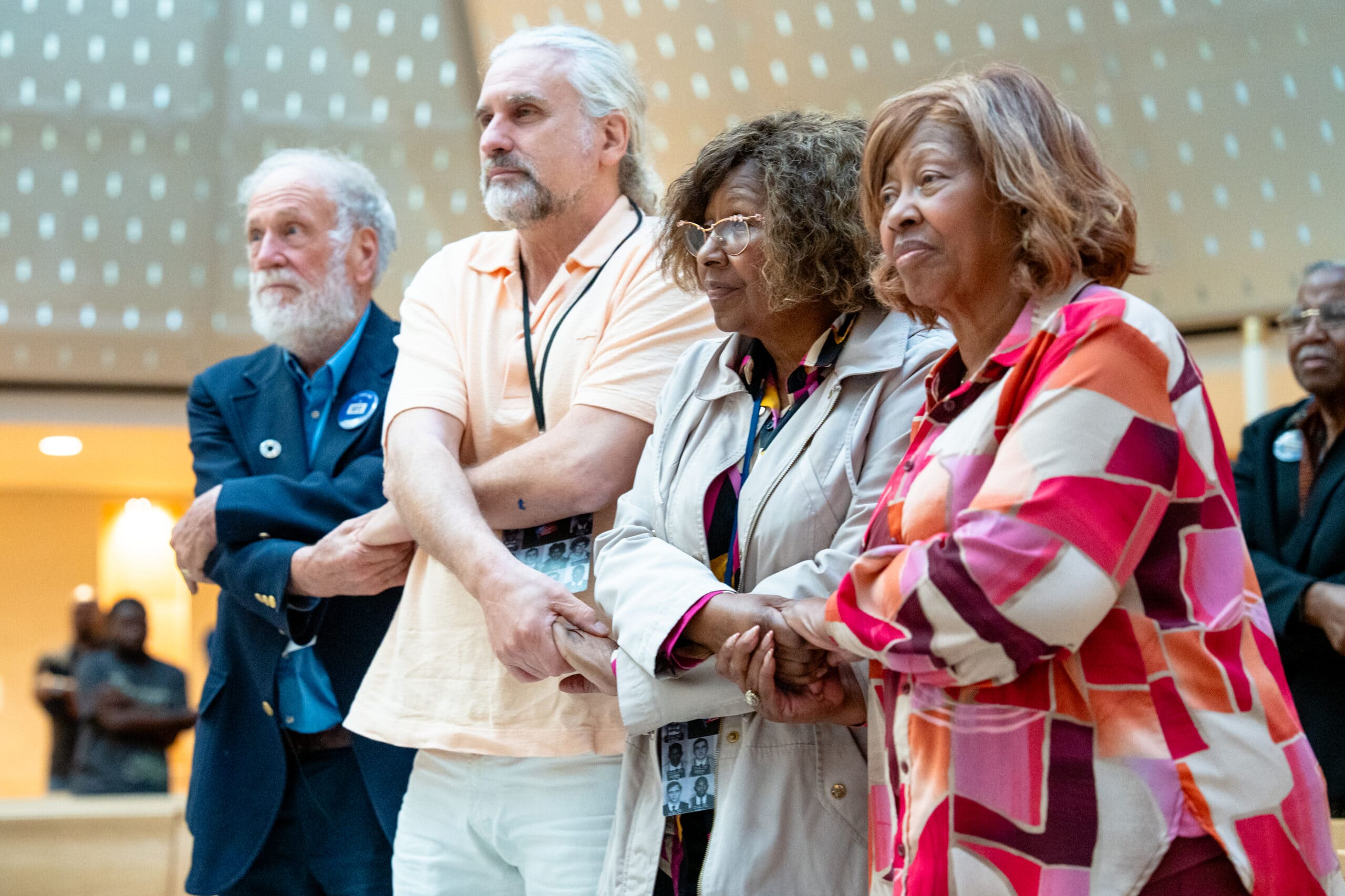 Freedom Riders and descendants Steve Thomas, left, Max Heller, center left, Margaret Petway, center right, and her sister Kredelle Petway-Phillips hold hands while singing at Xavier University on Oct. 28, 2026. Xavier University welcomed Freedom Riders and their descendants after a 12-day bus trip from Washington D.C. to New Orleans that traced their original planned route from 1961, which was never completed due to the extreme violence they encountered in Alabama.