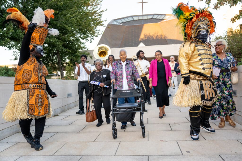 Doratha “Dodie” Smith-Simmons second lines out of the Xavier University chapel following a ceremony honoring Freedom Riders and their descendants on Oct. 28, 2026. Xavier University welcomed Freedom Riders and their descendants after a 12-day bus trip from Washington D.C. to New Orleans that traced their original planned route from 1961, which was never completed due to the extreme violence they encountered in Alabama.